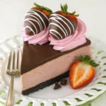 Whole chocolate strawberry cheesecake topped with pink cream swirls and chocolate-dipped strawberries.