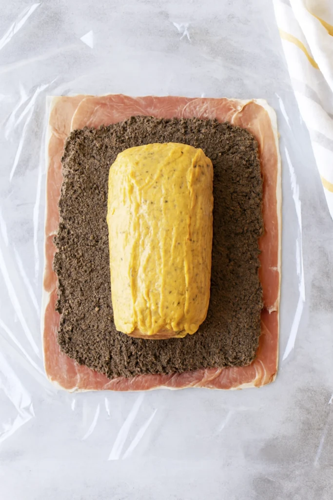 Medium-rare Beef Wellington with golden crust and mushroom duxelles layer