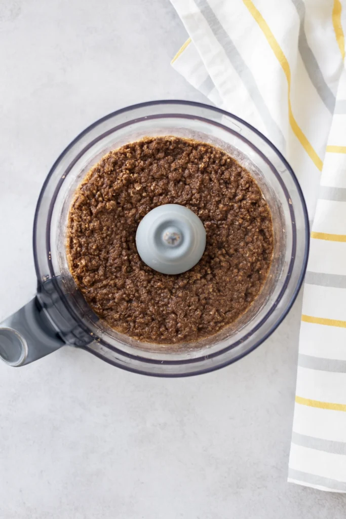 Gourmet Beef Wellington slice with salad greens, cherry tomatoes, rustic board, and striped napkin