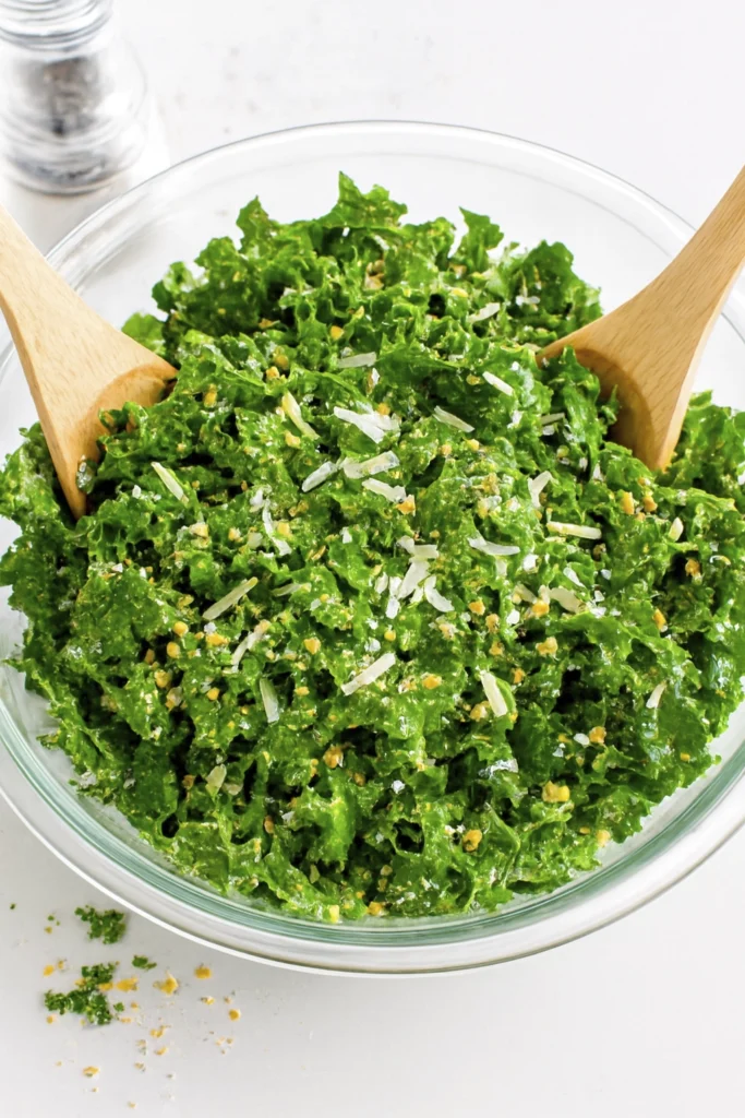 Quick kale salad with cheese and seeds in a glass bowl.