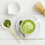 Matcha green tea latte (hot or iced) being whisked with a bamboo chasen until frothy