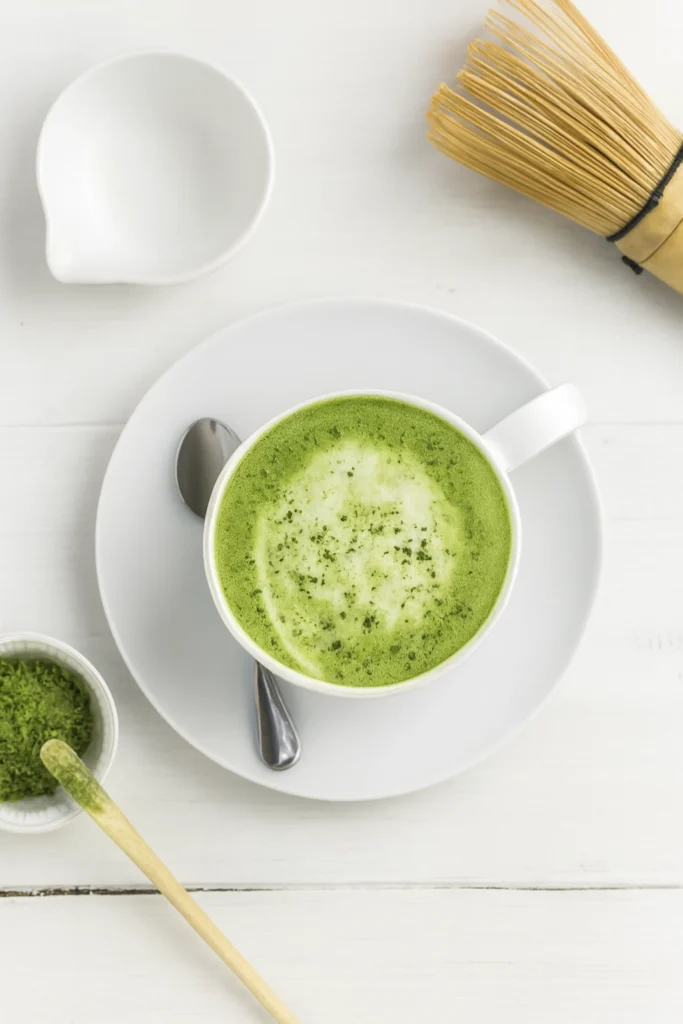 Finished Matcha green tea latte (hot or iced) served in a white cup with garnish