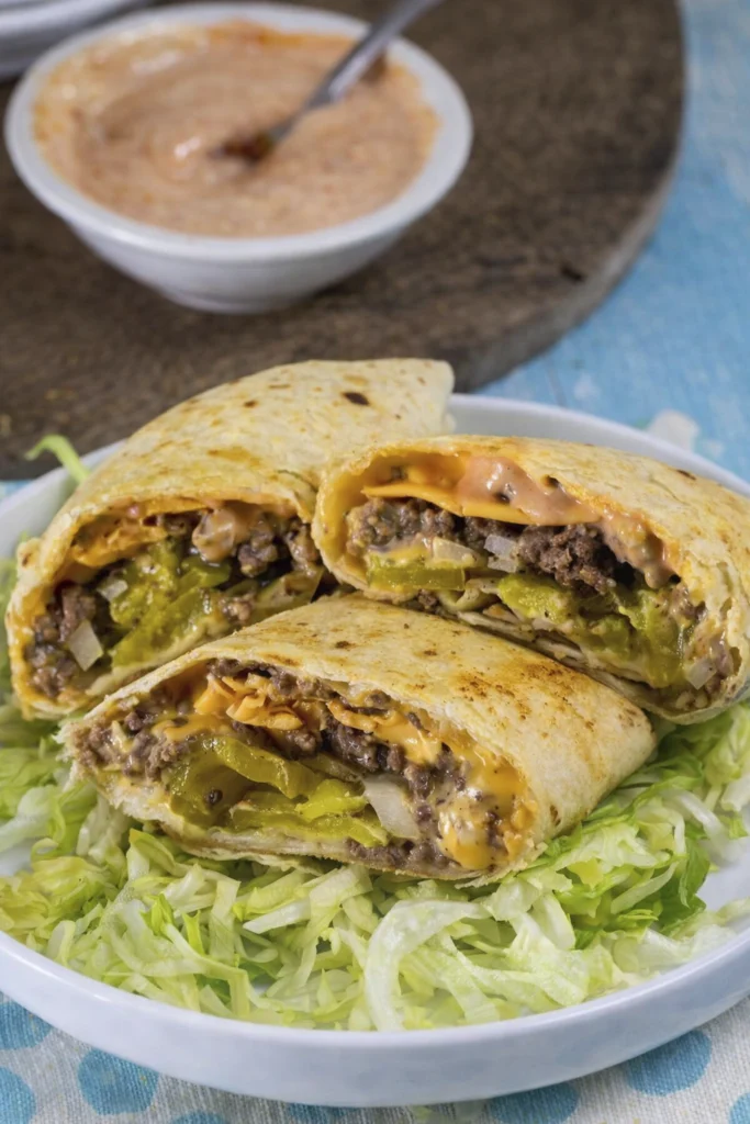 Grilled cheeseburger wraps with beef, cheese, pickles, onions, and dipping sauce