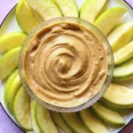 Plate of green apple slices arranged around a bowl of creamy Greek Yogurt Apple Dip